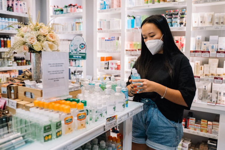 Woman in pharmacy examining products, illustrating consumer experience; concept for how to sell a pharmacy successfully.