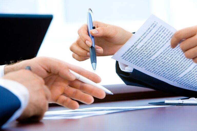 Two people discussing a Franchise Disclosure Document, emphasizing its comprehensive requirements.